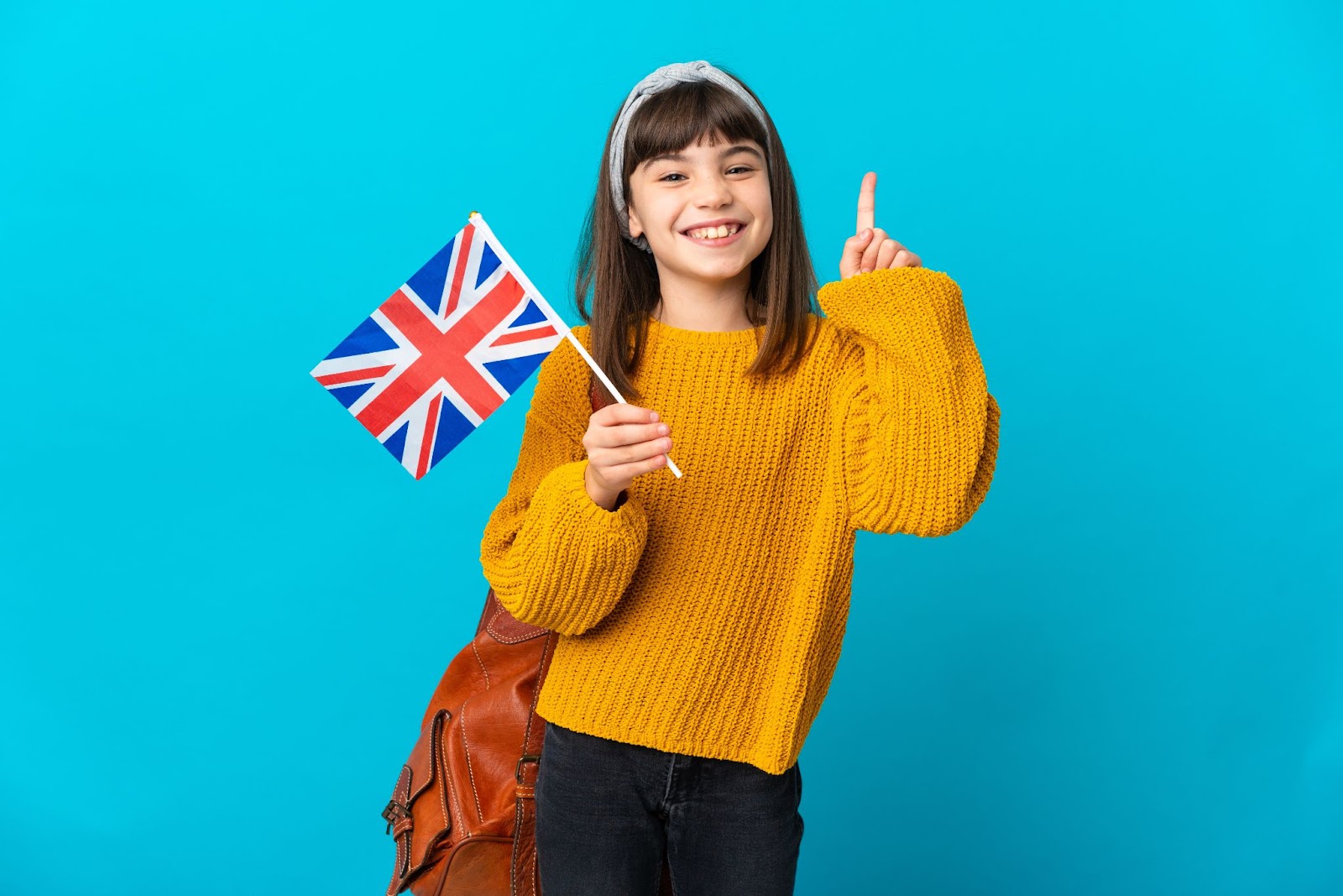 dziewczynka z flagą Wielkiej Brytanii na niebieskim tle